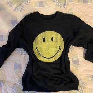 Smiley sweater. Has a few paint stains, can easily be removed.